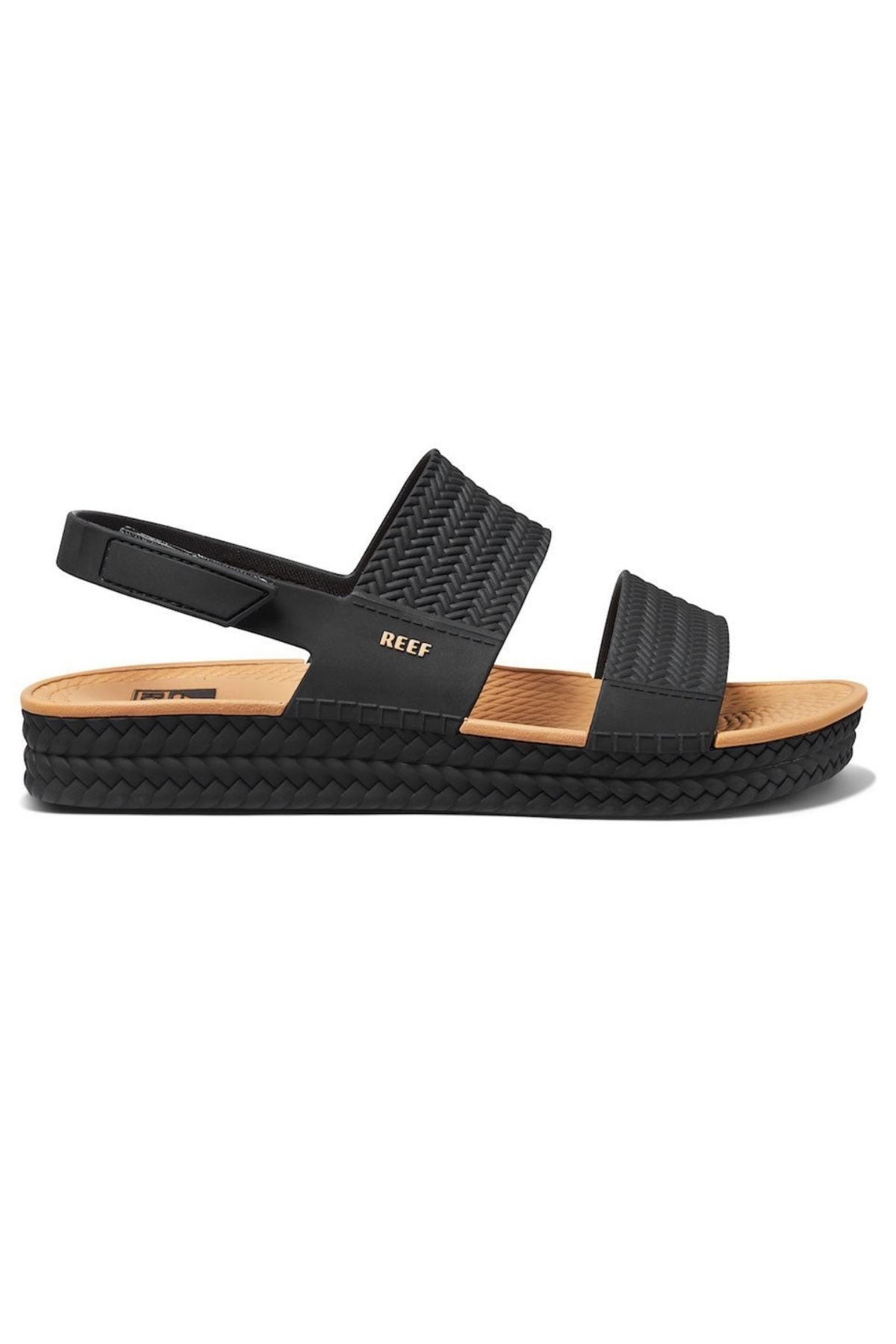The REEF Water Vista features a black sandal with two textured straps, an adjustable slingback, tan insole with patterned edges and arch support. It boasts a stylish woven-look sole and the brand name "REEF" on one strap, highlighting quality.
