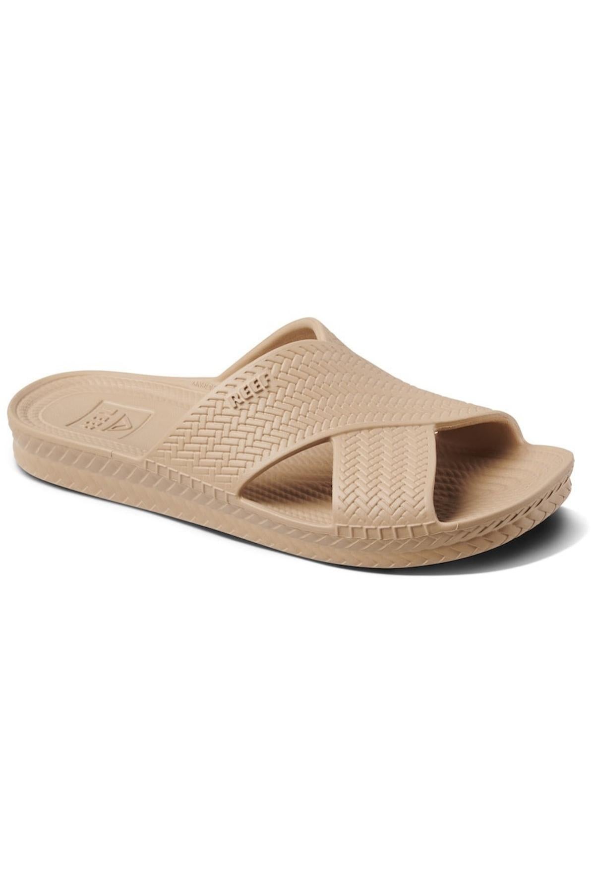 The REEF Water X Slide sandal features a waterproof EVA crisscross strap in beige, a sugarcane EVA footbed with a subtle pattern, and a slightly raised sole with textured edges for better grip.