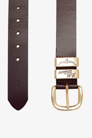 The RM Williams 1 1/2 3 Piece Solid Hide Belt in dark brown leather features a brass buckle, two gold keepers with elegant engraved text, and multiple adjustment holes. Made in Australia, this belt is adorned with an embossed kangaroo logo near the end. The image provides both front and back views of the belt.