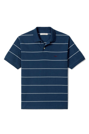 The RM Williams Albany Stripe Polo is a navy short-sleeve shirt with thin white stripes, a buttoned collar, and a small embroidered logo on the left chest.