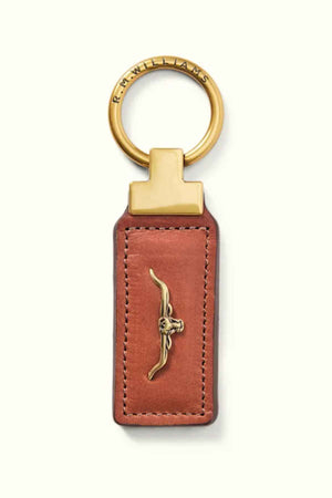 The RM Williams Angaston Key Fob is crafted from brown full-grain leather with antique brass hardware accents and features an embossed longhorn design. It has a keyring made in Australia, engraved with "R.M.WILLIAMS.