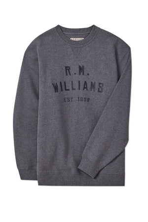 The RM Williams Bale Sweatshirt in heather grey fleece features "R.M. Williams Est. 1932" boldly on the front, capturing classic outback style. The crewneck is displayed flat on a white background for a clean, modern look.