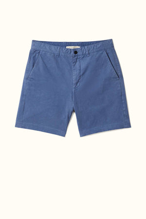 The RM Williams Berwick Chino Short, offered in blue, is a pair of casual men's shorts made from organic cotton. It features side pockets, belt loops, and a front button closure. Designed as modern tailored shorts with comfort stretch for easy movement, they are showcased on a light background.