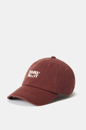 The RM Williams Branded Twill Cap is a maroon organic cotton cap with white embroidered text on the front, an adjustable strap for comfort, and is displayed against a plain white background.