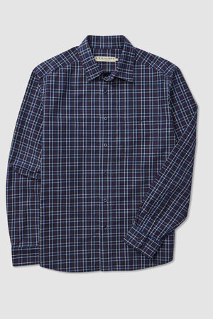 The RM Williams Classic Shirt is a dark blue long-sleeve button-up with a collar and features a sophisticated checkered pattern of thin blue, red, and white lines. This smart casual, regular fit shirt includes a single chest pocket on the left side and is crafted from organic cotton. The shirt is neatly displayed flat against a white background.