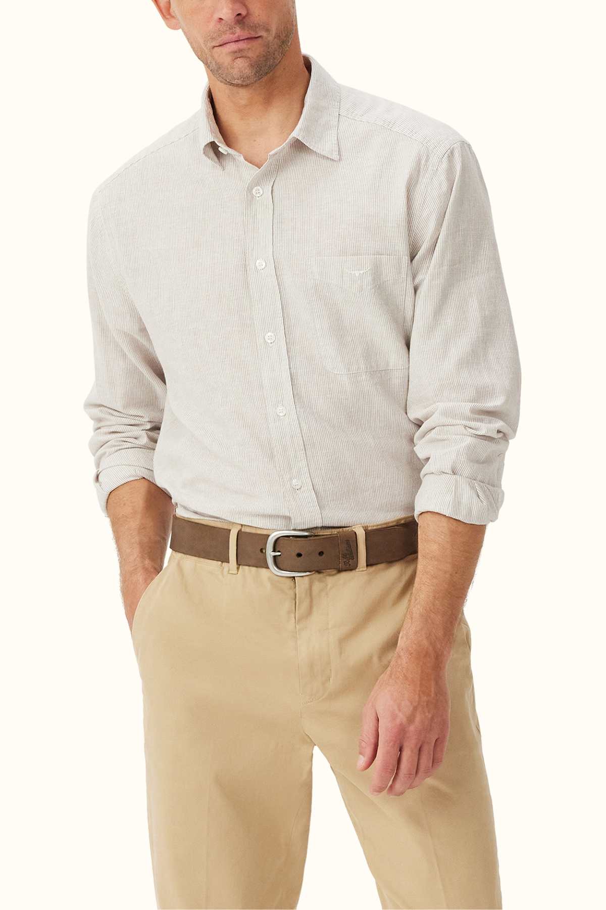 A man wearing an RM Williams Classic Shirt paired with khaki shorts exudes effortless style.