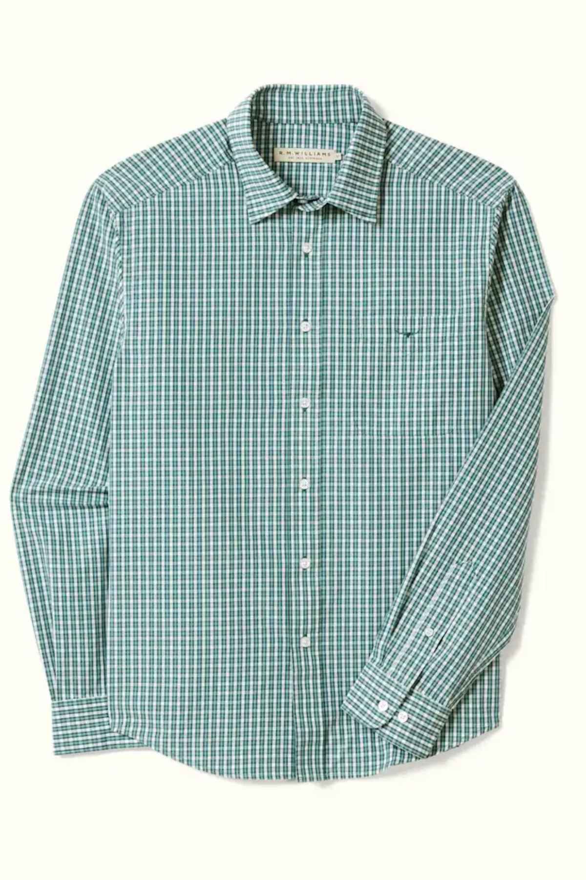 The RM Williams Classic Shirt is a green, long-sleeve button-up featuring a white gingham check pattern. Made from cotton poplin, this classic fit shirt includes a pointed collar, a single chest pocket, and white buttons along the front and cuffs.