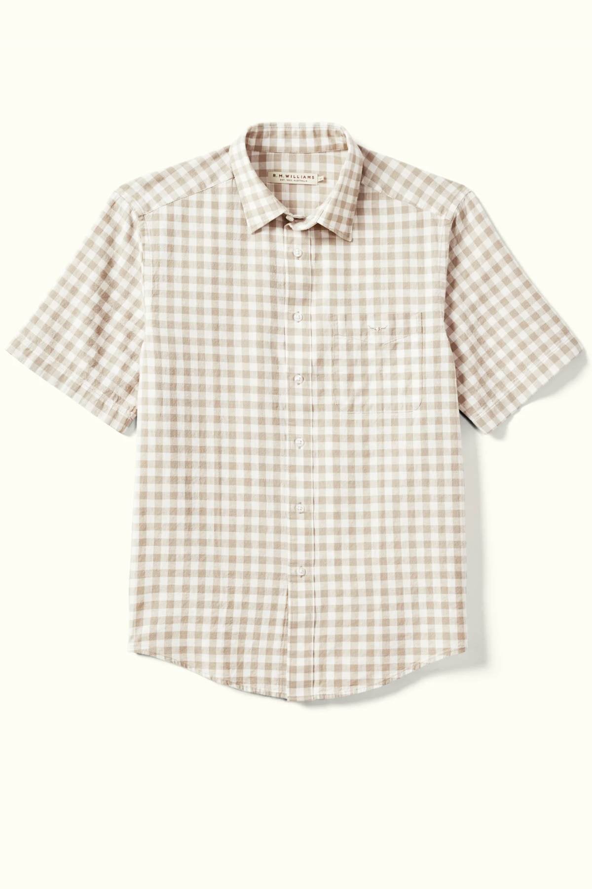 The RM Williams Classic Short Sleeve Shirt showcases a beige and white gingham pattern on a light background with its short sleeves and button-up design.