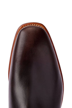 Close-up of the toe of a polished dark brown RM Williams Comfort Craftsman Boot, showcasing detailed stitching around the edge with a light brown trim, reminiscent of high-quality craftsmanship synonymous with Australian footwear.