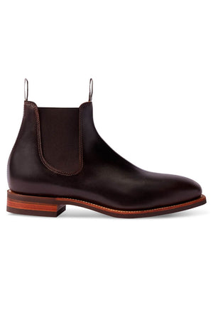A single RM Williams Comfort Craftsman Boot, made of smooth and polished pull-up leather, is displayed against a white background. It features elastic side panels, pull tabs on the front and back, and a wooden sole with a slight heel. Made in Australia, this brown leather Chelsea boot exudes elegance and durability.