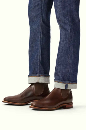 RM Williams Comfort Craftsman Boot in the colour Walnut. Model wearing boots, side angle