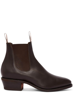 A single RM Williams Comfort Lady Yearling Rubber Sole Boot, featuring a brown leather Chelsea design with a block heel and elastic side panels, enhanced with pull tabs for easy wear. This stylish boot is showcased side-on against a plain white background.