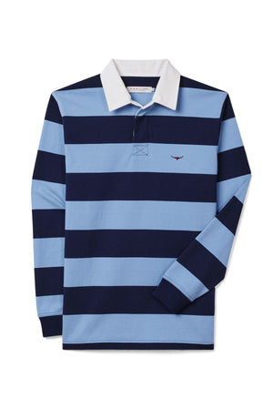 The RM Williams Cradle Rugby is a striped rugby shirt made from organic heavyweight fabric, featuring wide navy and light blue stripes, a white collar, and a small red embroidered logo on the left chest.