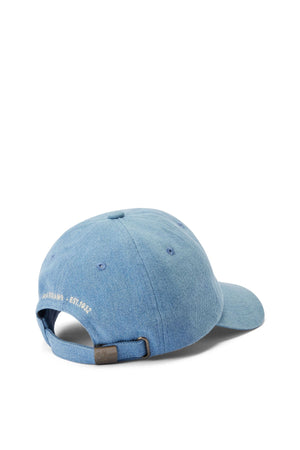 The RM Williams Cursive Twill Cap, in light blue organic cotton, features an adjustable strap with a metal clasp and small white embroidered text at the back for comfort and classic style.