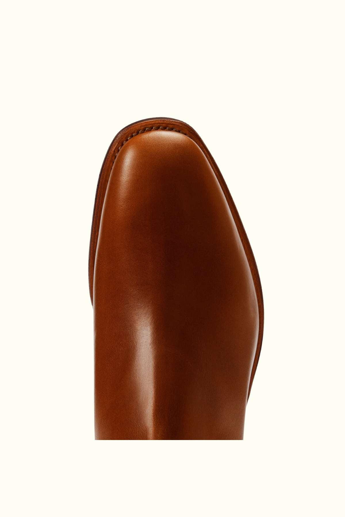 Close-up view of the toe area of the RM Williams Dynamic Flex Craftsman Boot in polished brown leather, set against an off-white background.