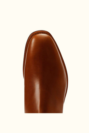 Close-up view of the toe area of the RM Williams Dynamic Flex Craftsman Boot in polished brown leather, set against an off-white background.