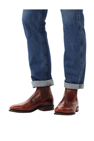 A person wearing cuffed blue jeans and brown leather RM Williams Dynamic Flex Craftsman Boot made with yearling leather.