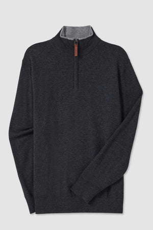 The RM Williams Ernest Sweater is a dark grey long-sleeve pullover with a quarter zip and a high collar, made from a fine gauge merino wool blend. The inner lining of the collar is light grey, providing a subtle contrast to the main body of the sweater, while the zipper features a small brown leather pull tab. The sweater is showcased against a plain white background.