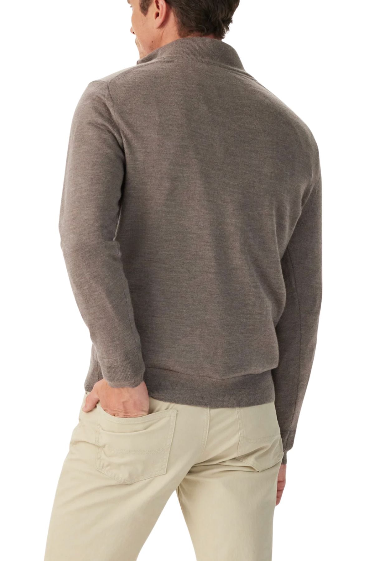 A man is shown from the back, with one hand in his pocket, wearing the RM Williams Ernest Merino 1/4 Zip Knit sweater in light brown and beige pants against a white background.
