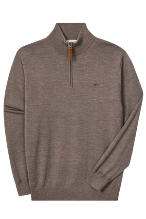 The RM Williams Ernest Merino 1/4 Zip Knit is a brown pullover sweater made from extra-fine merino wool, featuring a stand collar, ribbed cuffs and hem, a small red chest logo, and a zipper with a tan leather pull tab.