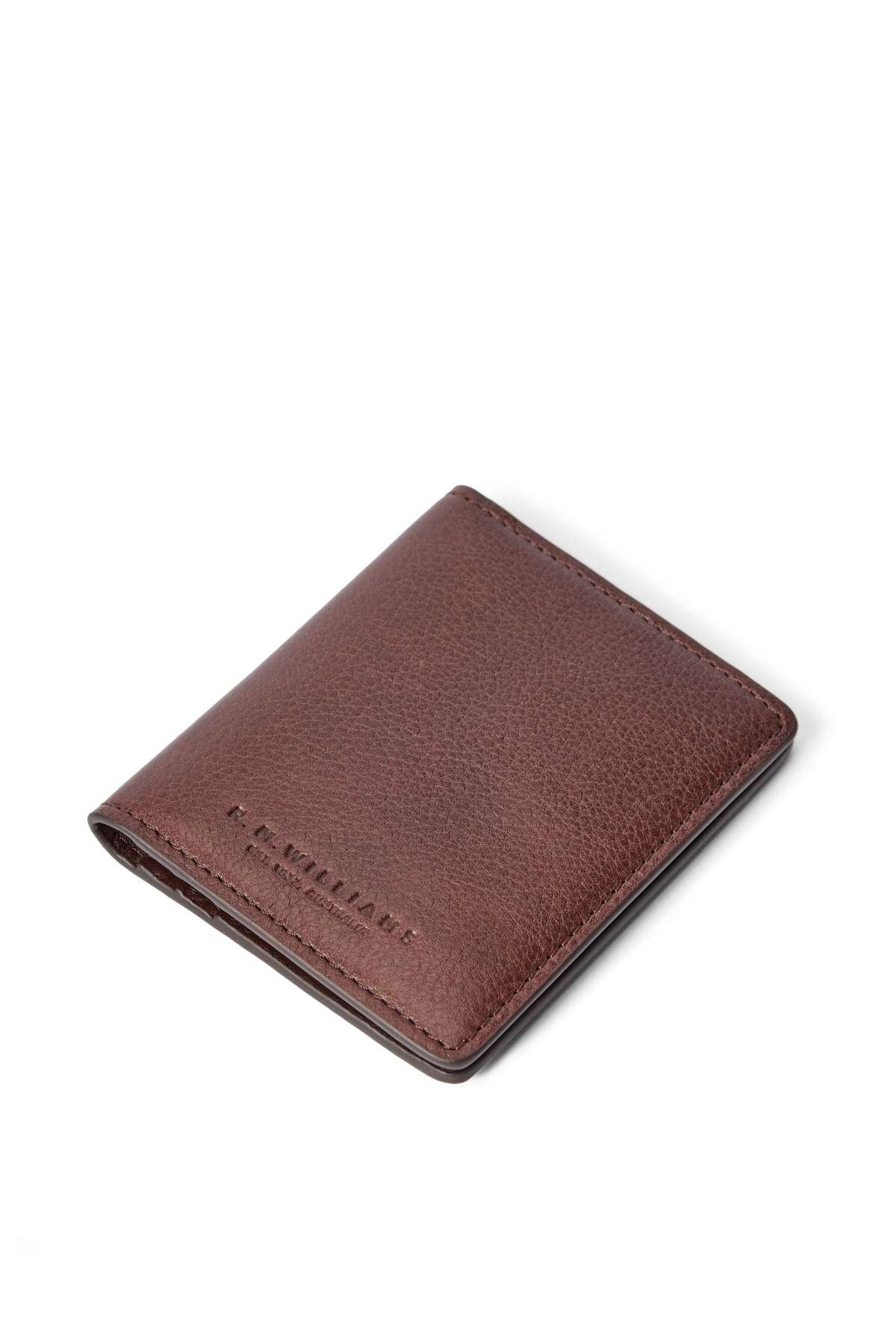 The RM Williams Farrier Fold Cardholder is displayed closed and angled on a white background, featuring brown textured leather and subtle stamped text in the lower left corner.