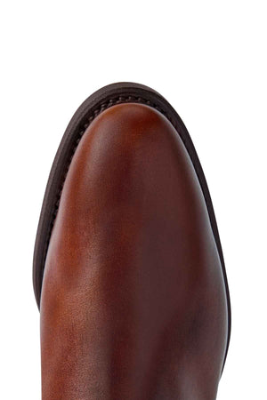 Close-up of the RM Williams Comfort Lady Yearling Rubber Sole Boot toe, crafted in rich Spanish pull-up leather with a rounded shape, dark edge stitching, and smooth texture. Handmade in Australia, it showcases exquisite craftsmanship.