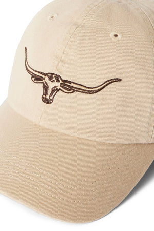 The RM Williams Longhorn Twill Cap is made from organic cotton twill in beige, featuring a brown embroidered steer head on the front. It includes an adjustable strap and ventilation eyelets for comfort and a secure fit.