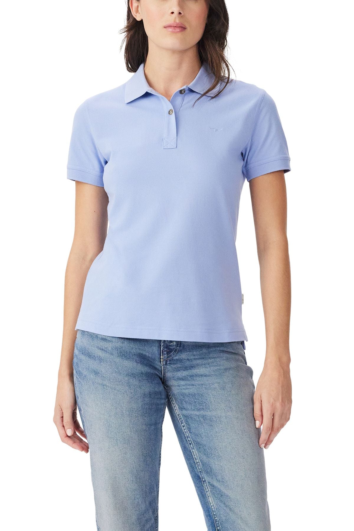 A person wearing the RM Williams Margaret Polo in light blue and matching jeans stands against a white background.