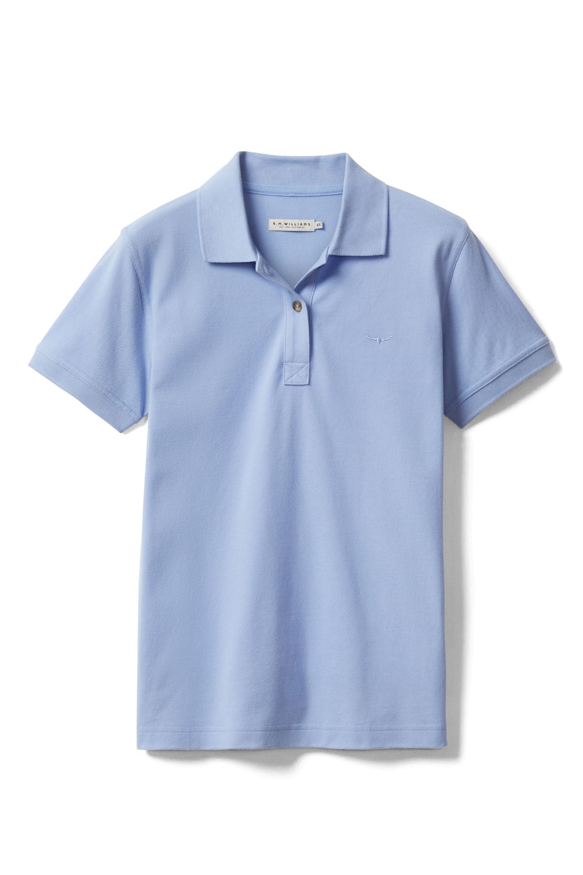The RM Williams Margaret Polo is a light blue short sleeve shirt with a collar, two buttons, and a small Longhorn embroidery on the left chest, crafted from soft pique cotton. Laid flat against a white background.