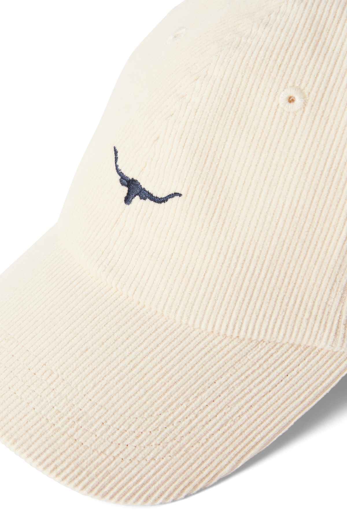 RM Williams Mini Longhorn Cord Cap in the colour cream. Close up of front of cap