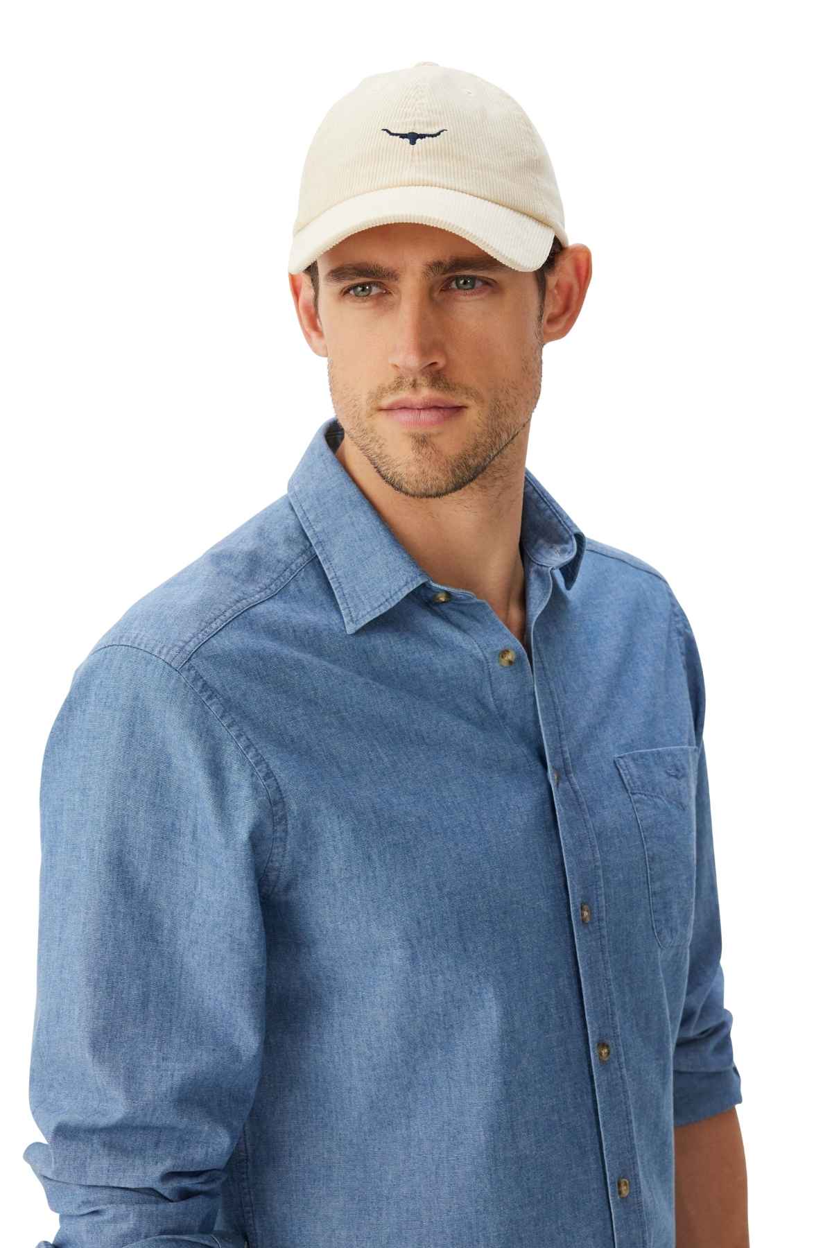 RM Williams Mini Longhorn Cord Cap in the colour cream. Man modelling cap