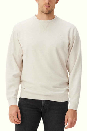 RM Williams Mini Longhorn Sweatshirt in the colour Ecru. Front angle of model wearing jumper