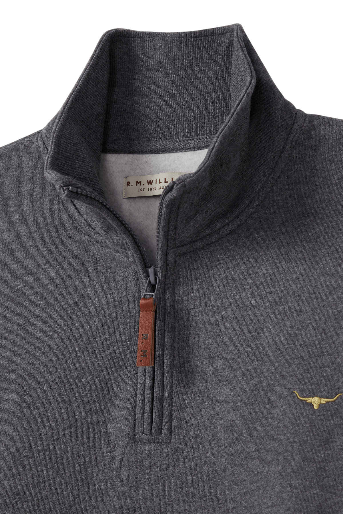 The RM Williams Mulyungarie Fleece is a charcoal gray quarter-zip sweatshirt with a brown leather zipper pull, a small yellow longhorn logo on the chest, and an R.M. Williams label inside the collar.