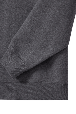 Close-up of the long sleeve and waistband of the RM Williams Mulyungarie Fleece in dark gray, highlighting ribbed cuffs and hem made from soft brushed cotton fleece, set against a white background.