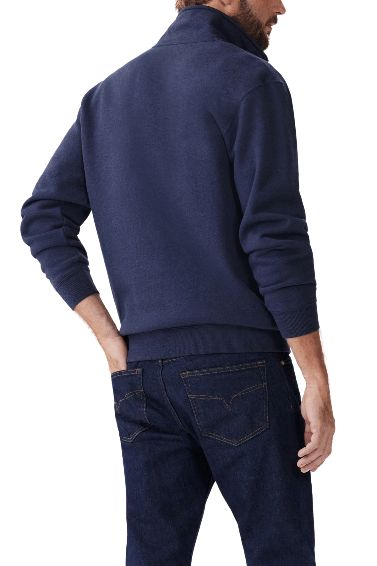 A man wears the RM Williams Mulyungarie Fleece, a dark blue quarter-zip sweatshirt, paired with denim jeans. Captured from the side and back, the image showcases this casual brushed cotton fleece outfit, with his hand in a pocket.