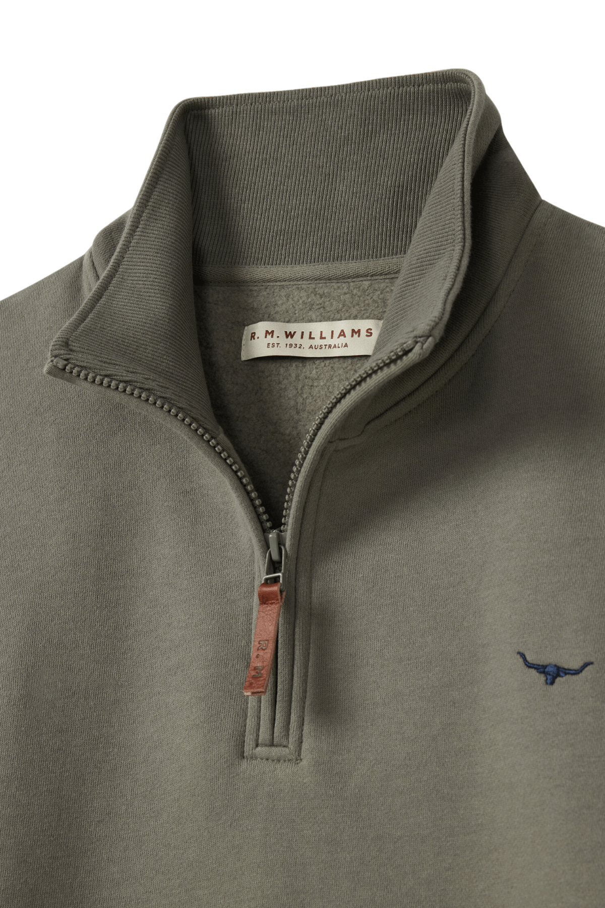 Close-up of an olive green RM Williams Mulyungarie Fleece quarter-zip sweatshirt featuring a stand-up collar, brown leather zipper pull, and small embroidered bull logo on the chest. The inside label reads “R.M. Williams.”.