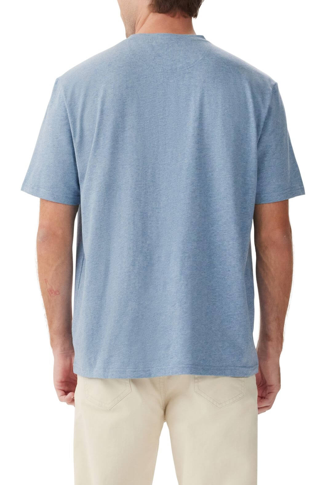 The person is seen from the back wearing an RM Williams Parson T-Shirt in light blue, complemented by beige pants. The breathable cotton, short-sleeved tee perfectly matches their light brown hair.