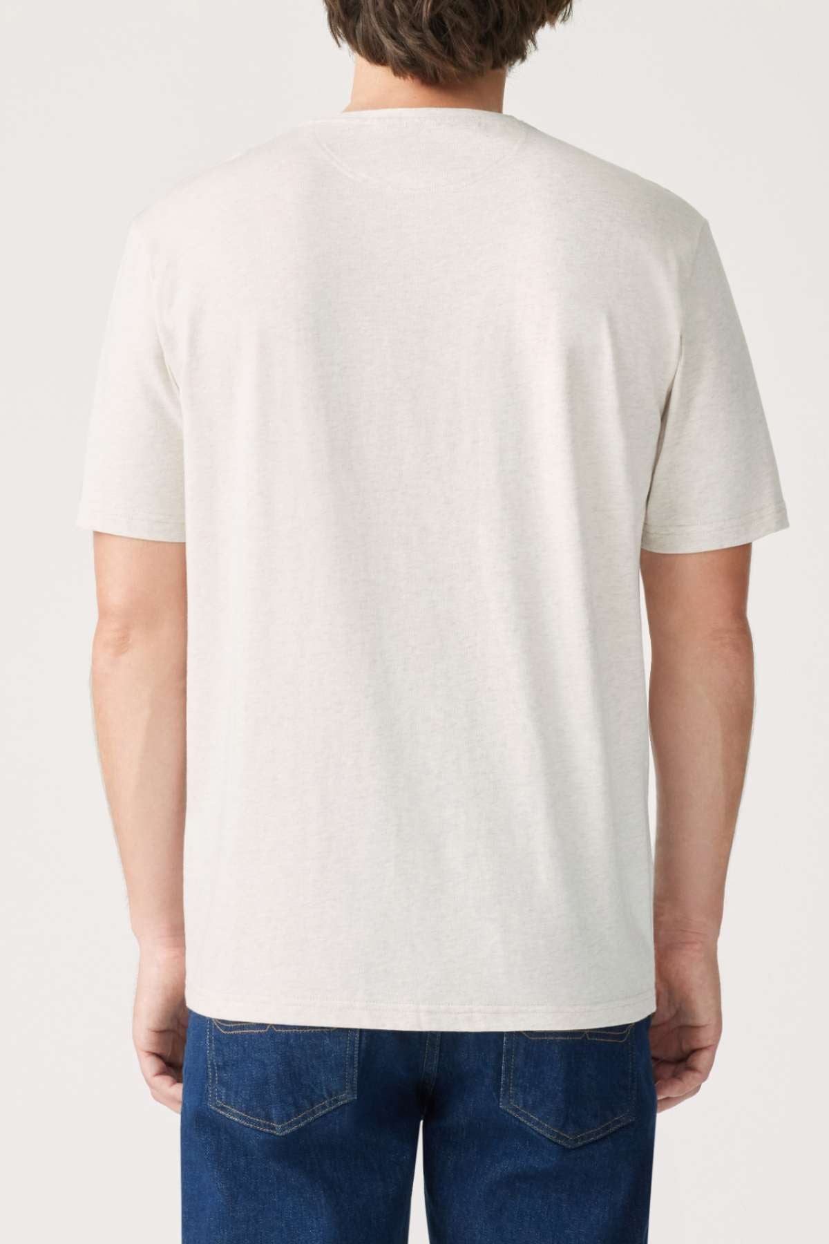 Rear view of a person wearing an RM Williams Parson T-Shirt made from mid-weight cotton jersey, paired with blue jeans, standing against a neutral background.
