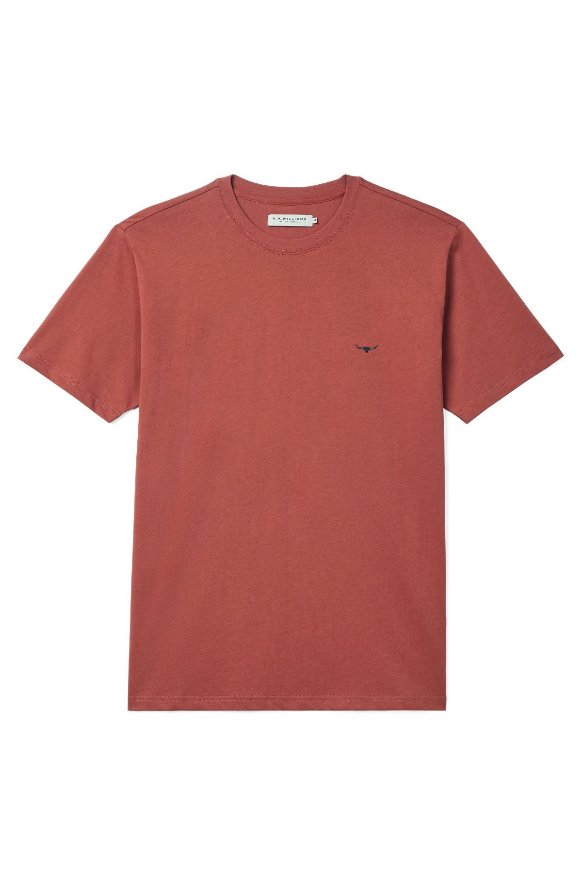 The RM Williams Parson T-Shirt is a plain, rust-red, short-sleeved tee in organic cotton jersey, featuring a small dark Longhorn logo embroidered on the left chest and displayed flat against a white background.