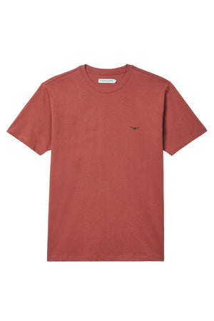 The RM Williams Parson T-Shirt is a plain, rust-red, short-sleeved tee in organic cotton jersey, featuring a small dark Longhorn logo embroidered on the left chest and displayed flat against a white background.