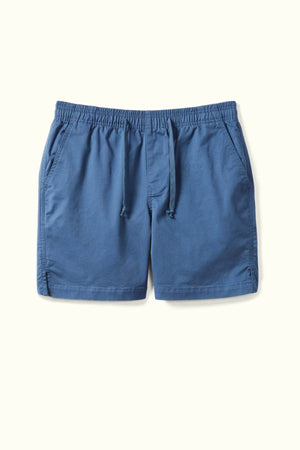 The RM Williams R.M.W Rugby Short, made from blue cotton and featuring an elasticated waist with a drawstring adjuster, side pockets, and a plain design, is displayed against a light background.
