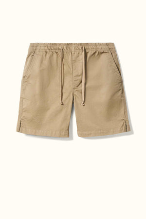 The RM Williams R.M.W Rugby Short in tan, made from washed cotton twill, features side pockets and an elasticated waist. It is displayed against a white background.