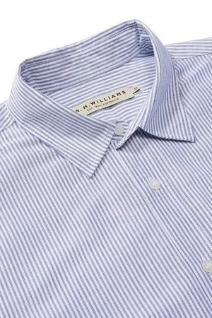 Close-up of a neatly folded RM Williams Regular Shirt in blue and white stripes, crafted from organic cotton. This slim fit button-up features a collar with a label at the collar area.