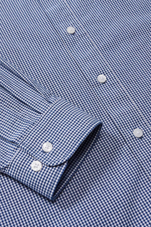 Close-up of the RM Williams Classic Shirt in a blue and white micro gingham check, highlighting its regular fit. The cuff is detailed with two buttons, accompanied by white buttons down the front, displaying sequential button details.