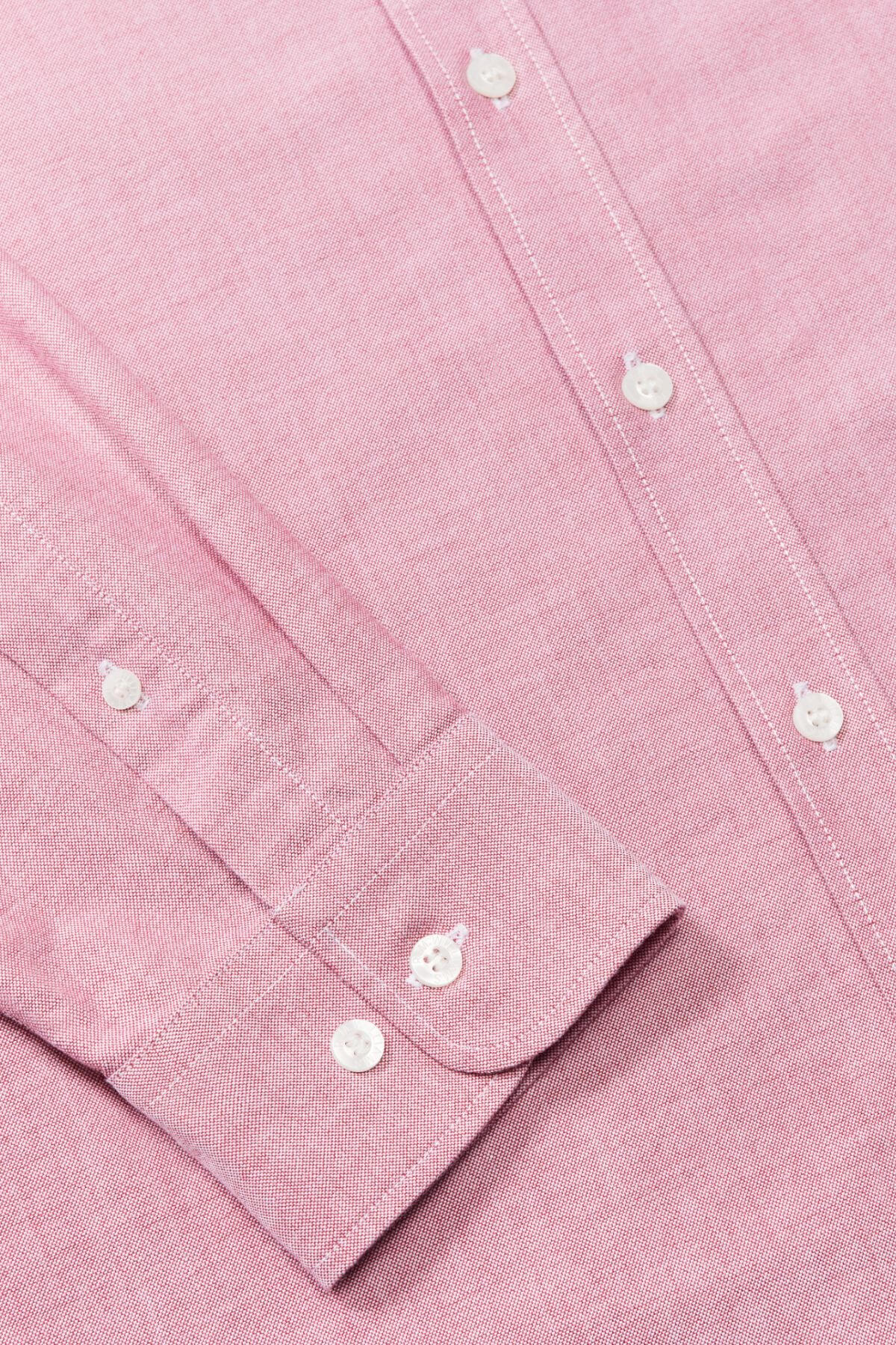 Close-up of the RM Williams Regular Shirt in pink organic cotton, featuring white buttons, visible stitching, and a neatly folded cuff.
