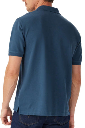 A man is shown from the back wearing the RM Williams Rod Polo, a short-sleeved blue shirt, paired with dark jeans.