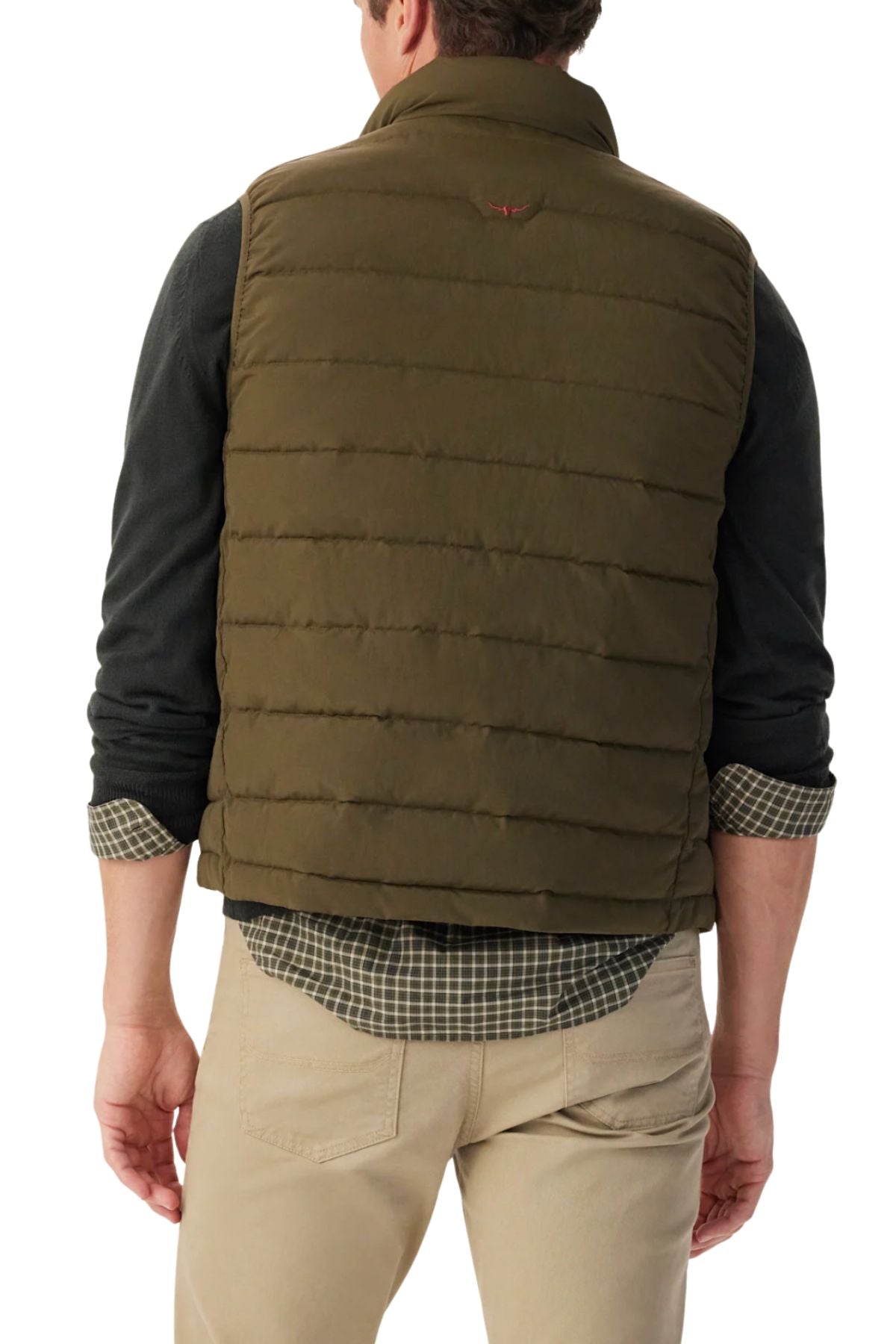 A man is shown from the back wearing the RM Williams Rydal Padded Vest in green over a dark long-sleeve shirt and checked shirt, paired with beige pants. His sleeves are rolled up and his hands rest at his sides.