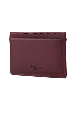 The RM Williams Singleton Vertical Card Holder is a brown leather cardholder with a smooth, minimalist design. It features two card slots on one side, subtle stitching along the edges, and RFID protection. The brand name "Hide & Sleek Urbanwear" is delicately embossed near the bottom center.