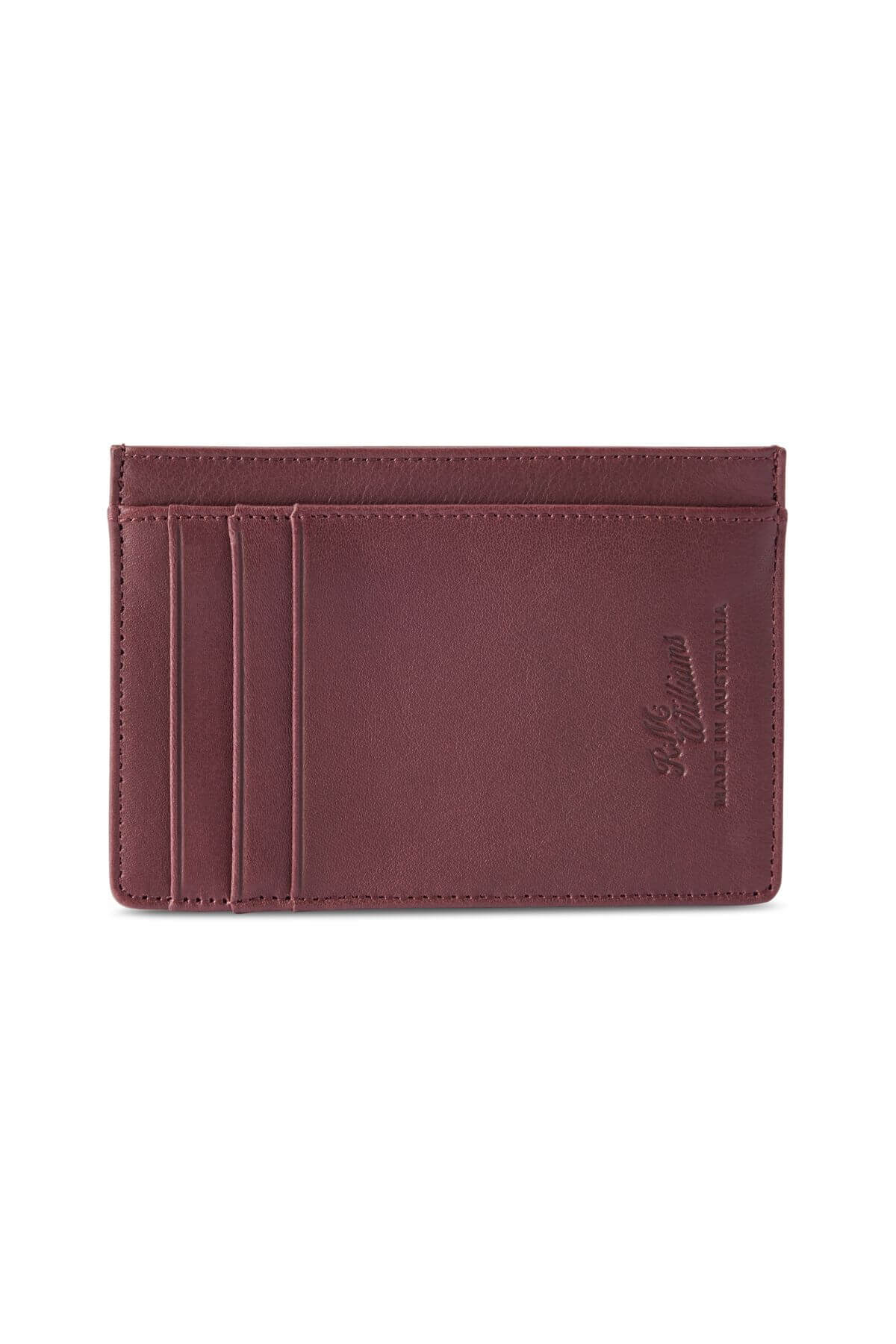The RM Williams Singleton Vertical Card Holder is a slim, rectangular brown card holder made of natural milled leather. It features three card slots on the left side and an embossed logo reading "H.J. Hammann - Handmade in Germany" on the right. The card holder includes RFID protection and showcases clean, minimalist stitching along its edges.