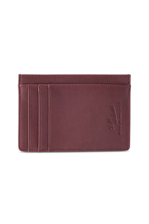The RM Williams Singleton Vertical Card Holder is a slim, rectangular brown card holder made of natural milled leather. It features three card slots on the left side and an embossed logo reading "H.J. Hammann - Handmade in Germany" on the right. The card holder includes RFID protection and showcases clean, minimalist stitching along its edges.